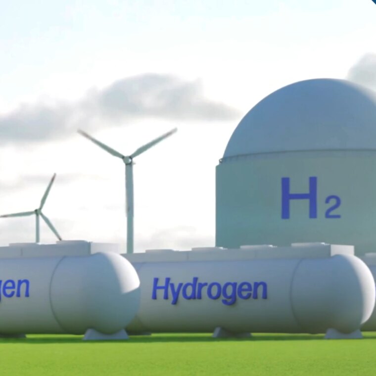 Green hydrogen plant with H₂ storage tanks and wind turbines